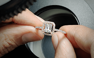 A professional retail setting showing the intricate details of finished jewellery pieces, representing the SGL Qualified Jewellery Specialist course.